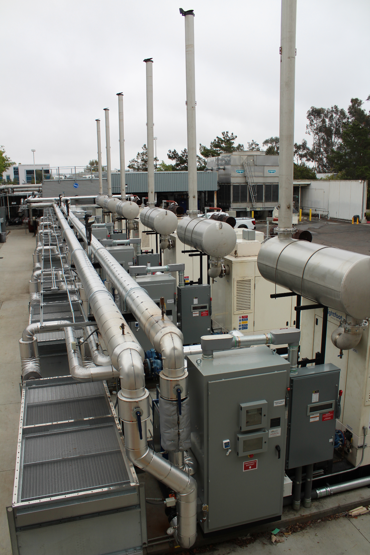 Exterior of a cogeneration plant with exhaust stacks and piping