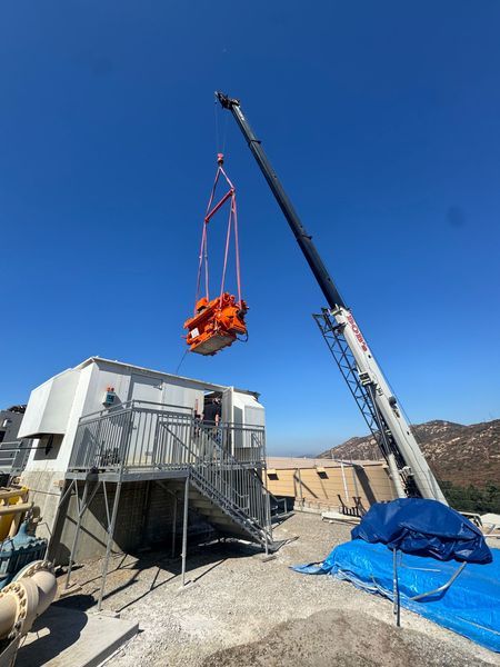 Crane lifting an engine into place at a customer site